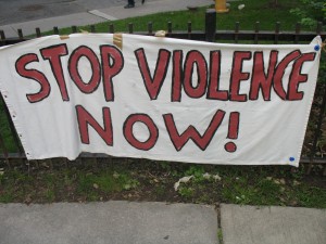 A banner reads "Stop Violence Now"