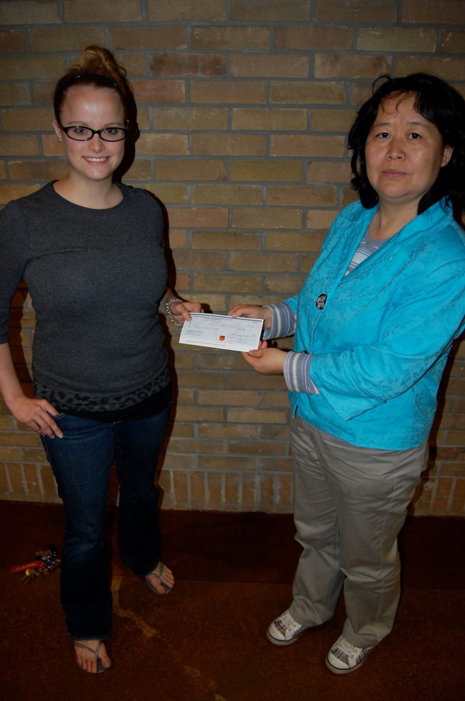 The Student Association’s board of directors helped Annie Zhou with a donation of $400. Julia K. Mackenzie, the SA's director of Internal Affairs, presents the cheque at the Casa Loma office. Photo: SA/Facebook 