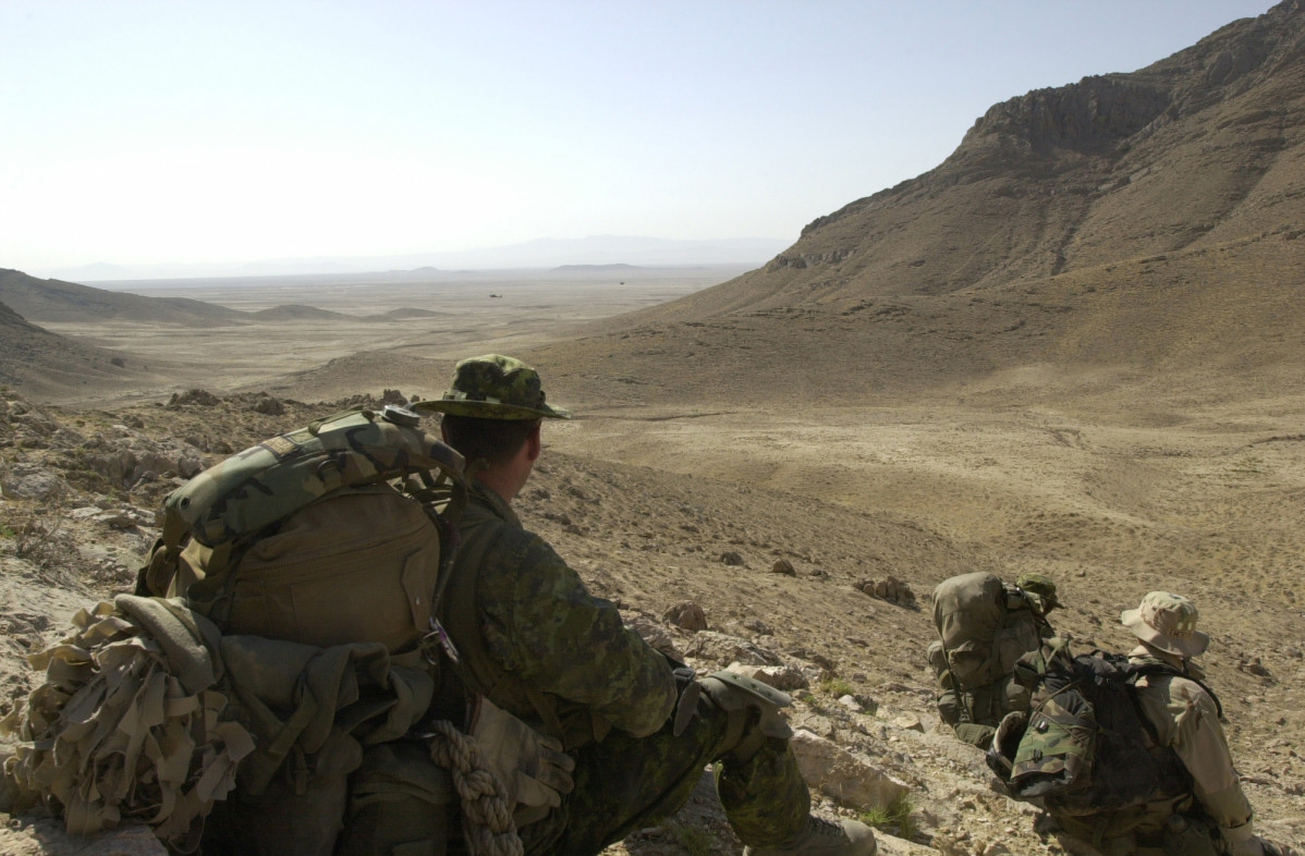 Canadian soldiers from 3PPCLI take a break as they move into the hills to search for Alqueda and Taliban fighters after an air assault onto an objective north of Qualat, Afghanistan on July 1, 2002. The soldiers are participating in Operation Cherokee Sky, an operation to locate and destroy remaining pockets of Al Queda and Taliban in support of Operation Enduring Freedom. (U.S. Army photo by Staff Sgt. Robert Hyatt) (Released)