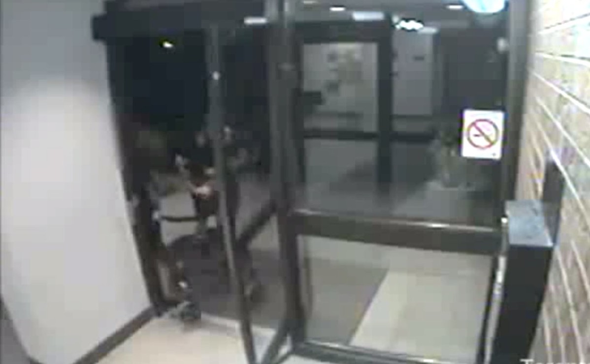 Security video image of a 91-year-old woman being robbed of her purse.
