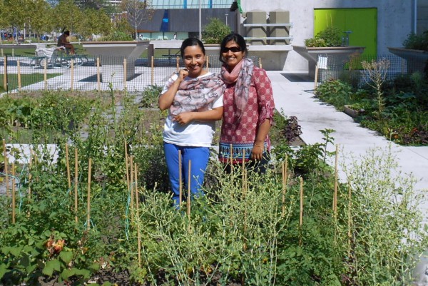 Image of two students Mireya Forero and Ashrafi Ahmed standing in the garden who are also the coordinators of CRC Regent Park food centre