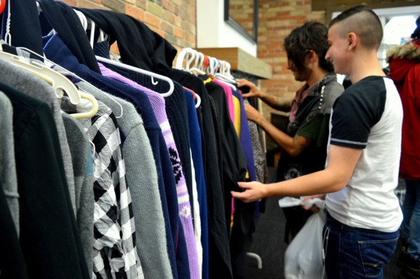 Image of people sorting and picking clothes on a hanger
