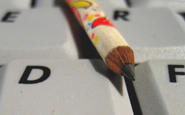 Image of pencil on a computer keyboard