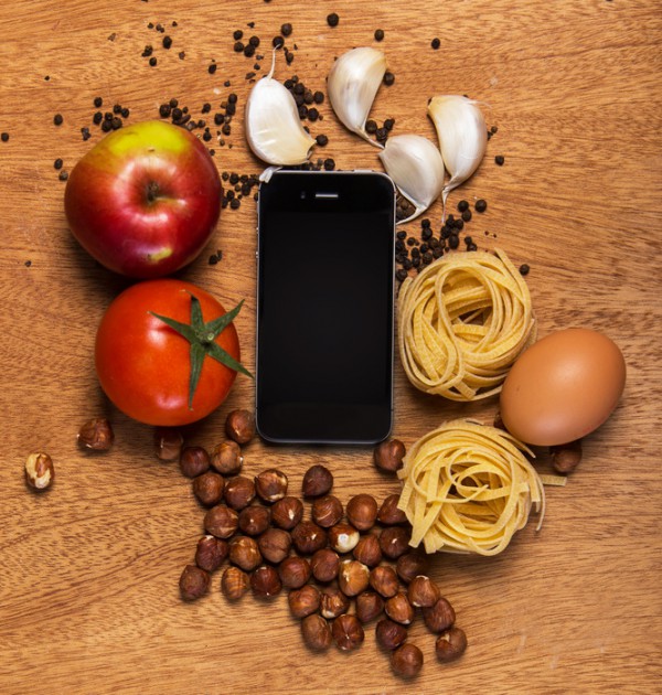 Image of Kitchen. Mobile phone and food on the table, an illustration for ritual app