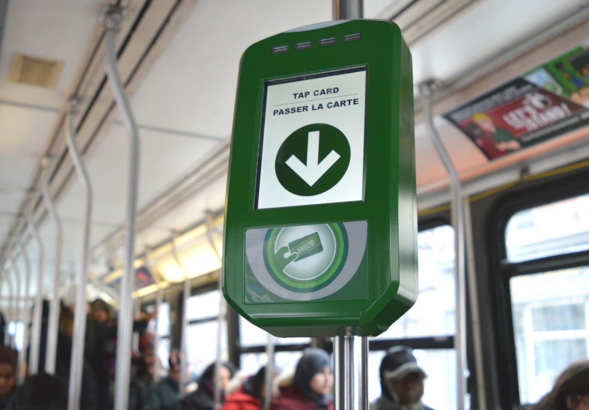 Image of a Presto card reader on a poll in a street car
