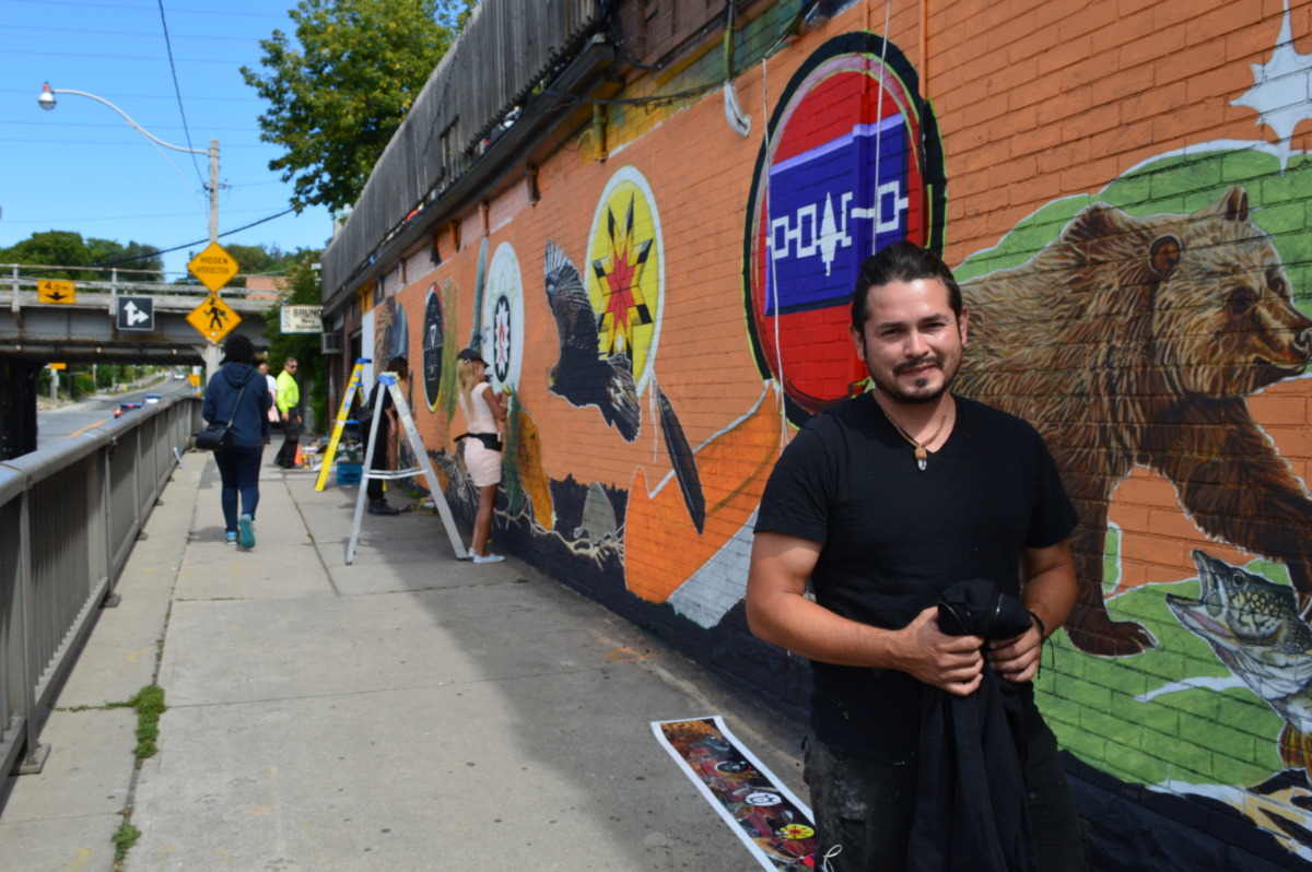 Cesar Rodriguez helped paint the new Indigenous themed mural at Spadina and Dupont. Photo: Megan Kinch / The Dialog