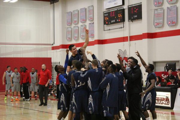 Vadim Halimov is lifted into the air by his teammates after sinking the winning basket with one second left and smashing two OCAA records in the process. Photo: Brittany Barber/The Dialog