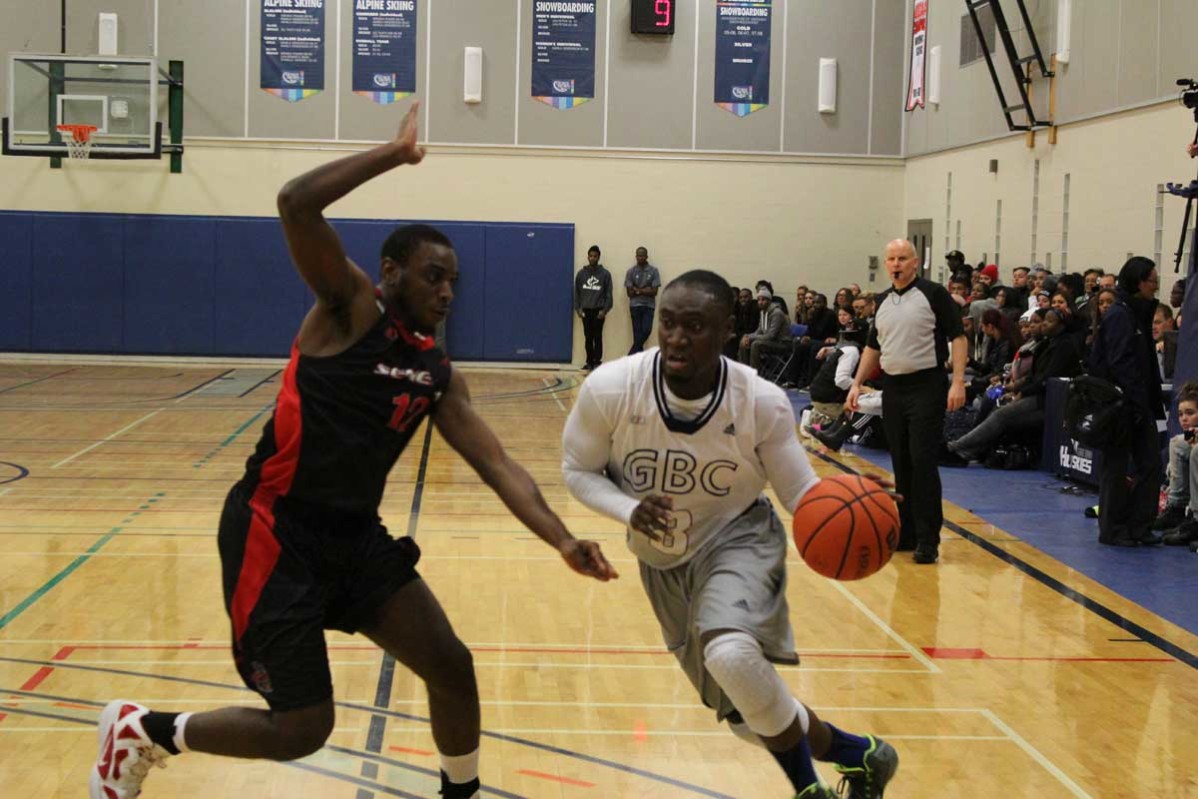 Curtis Baanee, right, of George Brown College dribbles past Adrian Tucker of the Seneca Sting in the Huskies' home opener on Oct. 22. Photo: Brittany Barber/The Dialog