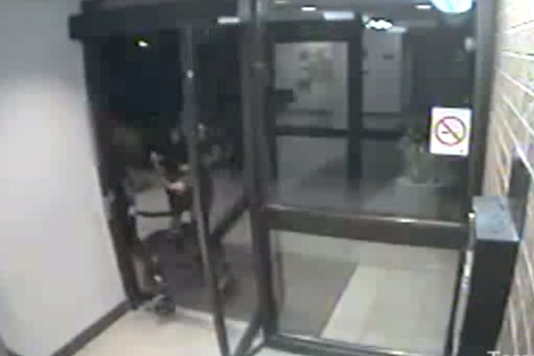 Security video image of a 91-year-old woman being robbed of her purse.