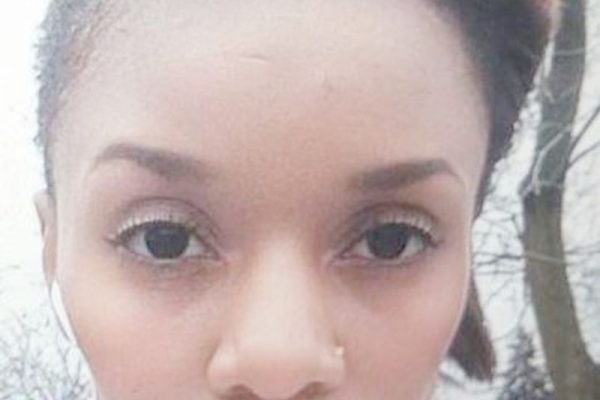Photo of Faty Habimana who is missing. She is described as 5'5", 95 lbs, with short black hair and light-brown highlights. She was last seen wearing a violet head scarf, burgundy pants, and a black-and-white checkered sweater. She was also wearing a black Calvin Klein winter coat and blue boots.