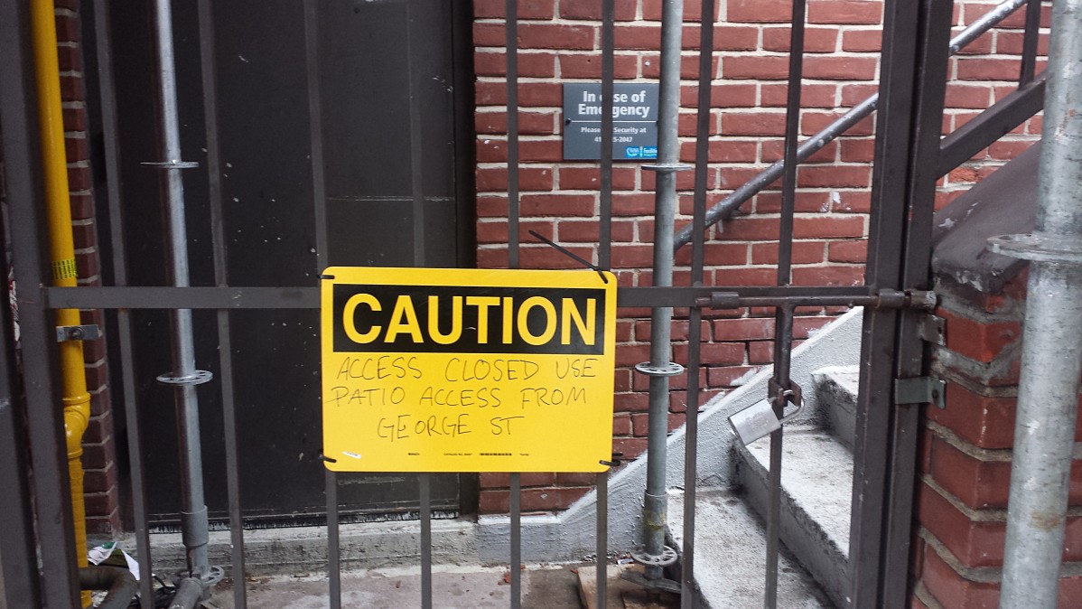 Image of Staircase sealed with bars and a caution notice