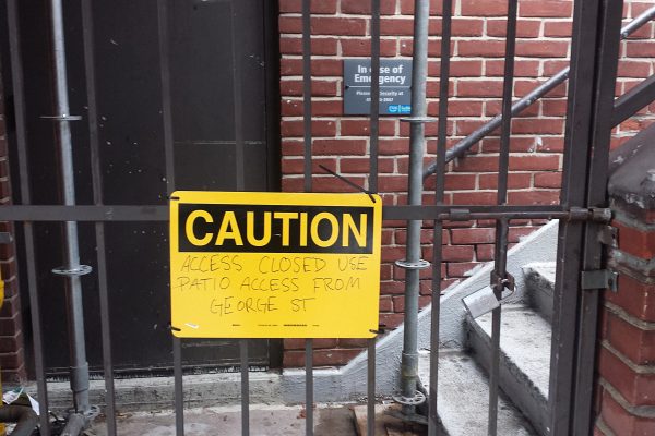 Image of Staircase sealed with bars and a caution notice