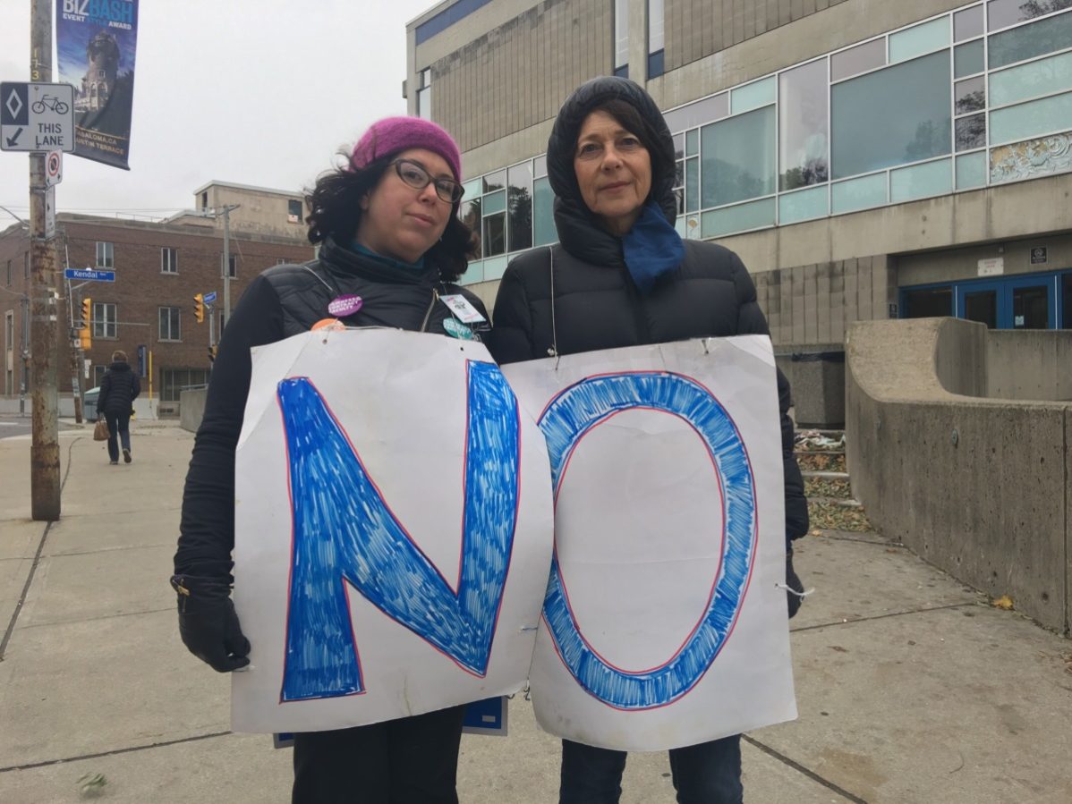 Two picketers at George Brown College's Casa Loma campus wear signs spelling "no" on the morning that striking college faculty rejected an offer fro the colleges by 86 per cent. Photo: Lidianny Botto / The Dialog