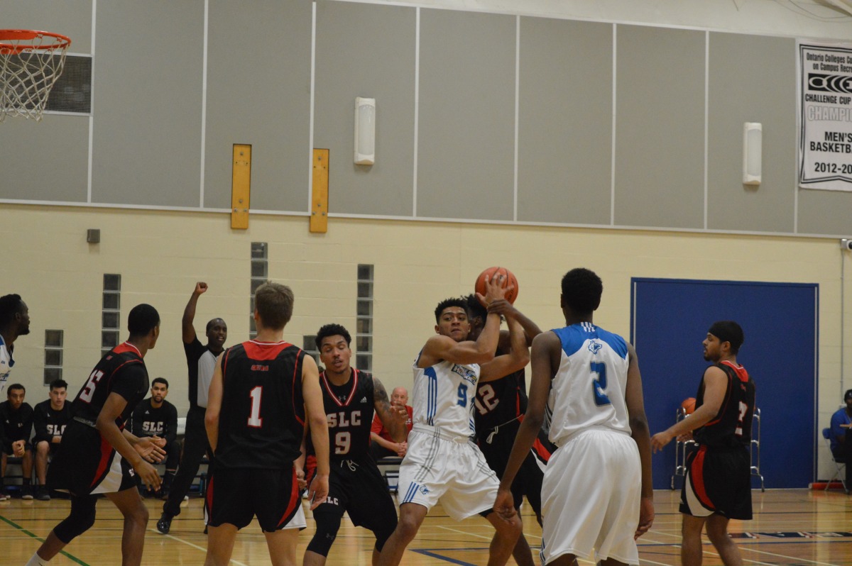 GBC men's basketball forward Adam Costanzo, #9 in centre, is among the Huskies leaders in points-per-game and is seen here battling for the ball in the Nov. 10 game against St. Lawrence College. Photo: Allison Preston / The Dialog
