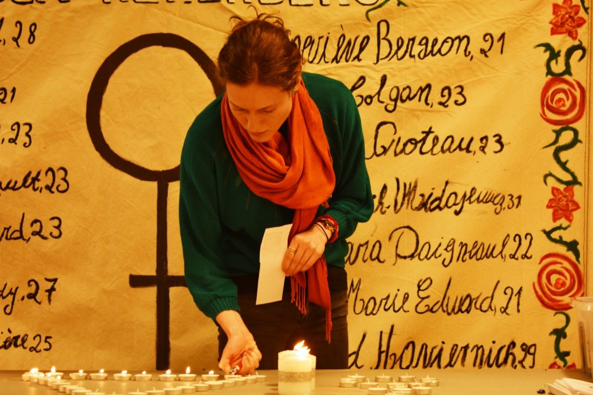 Sarah Alvo lights a candle in memory for Canada's fallen sisters at George Brown College on Dec. 3, 2018. Photo: Nico deVeber, / The Dialog